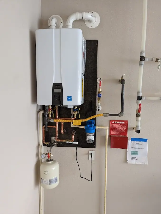 Professional plumber installing copper piping in a Marlboro Village home